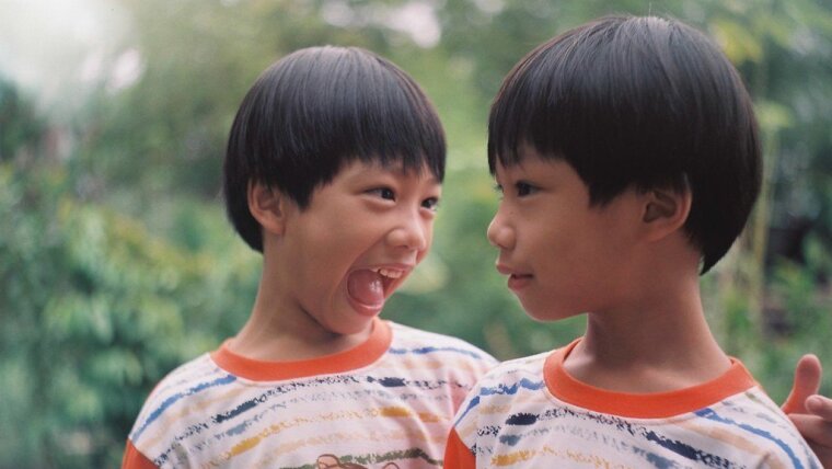 Two twins, one of them shouting