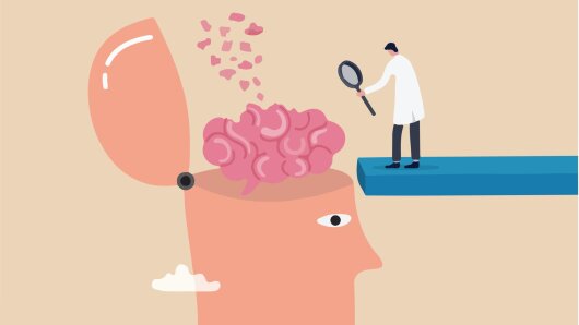 Ein Mensch untersucht ein Gehirn mit der Lupe